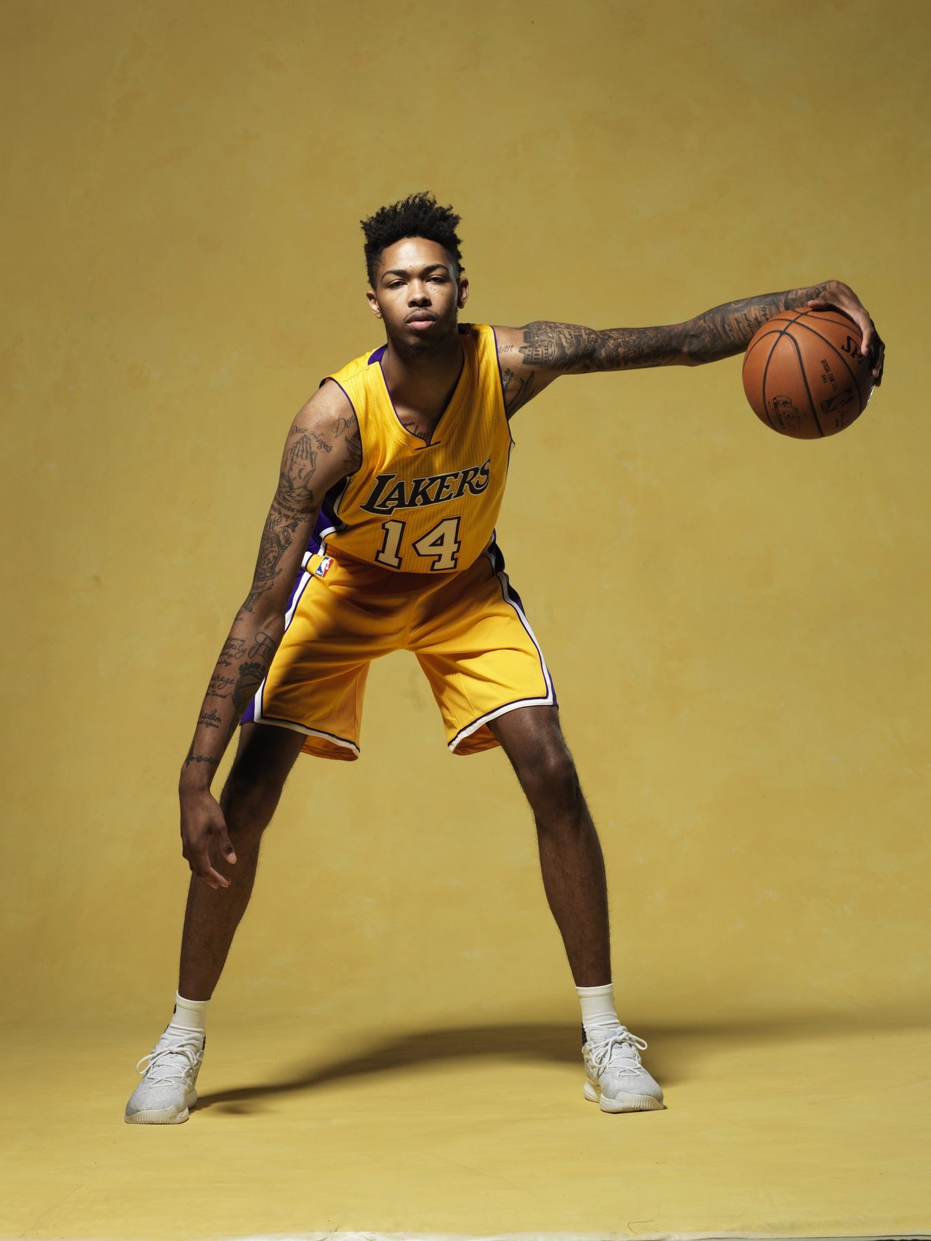 Studio portrait of Brandon Ingram in a Lakers uniform on a gold backdrop