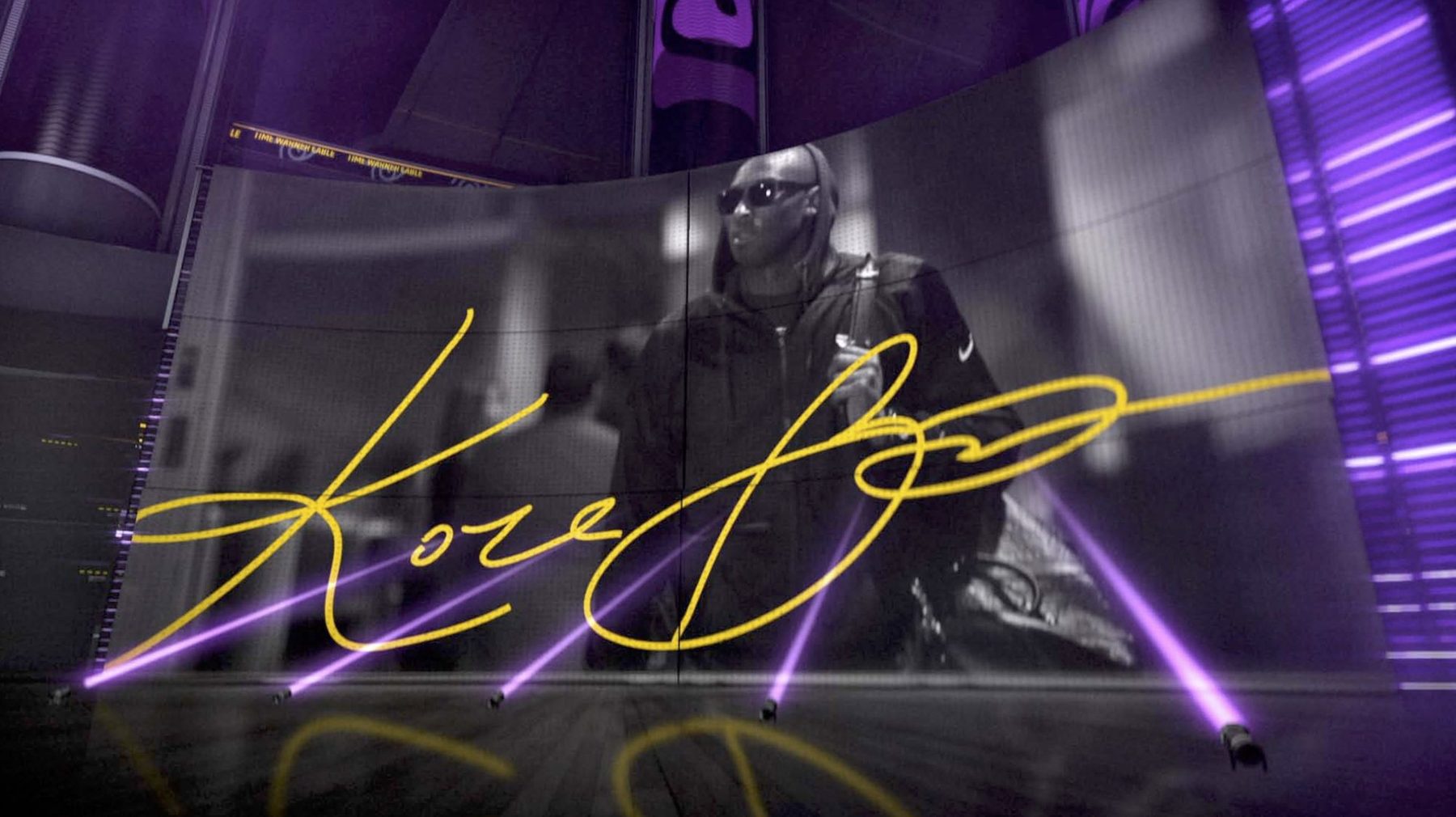 Studio video wall showing Kobe Bryant in black and white with a gold signature